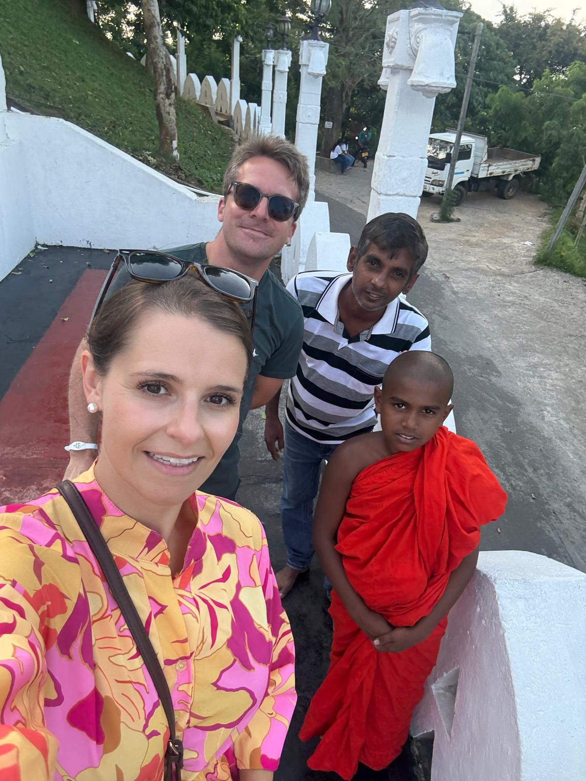Asanka in Kandy with happy tour guests and a young Buddhist monk