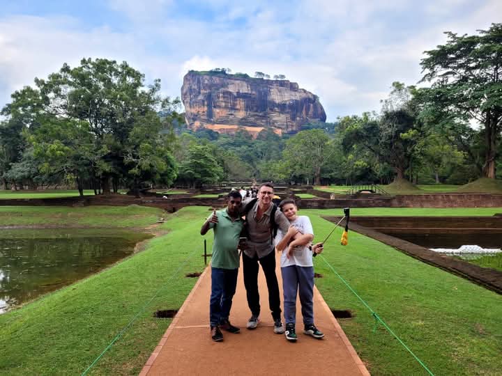 Asanka with guests in front of Sigiriya Rock fortress on a day trip from Kandy